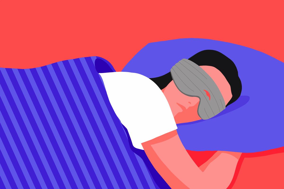 A girl lying in bed wearing the best weighted sleep mask for side sleepers