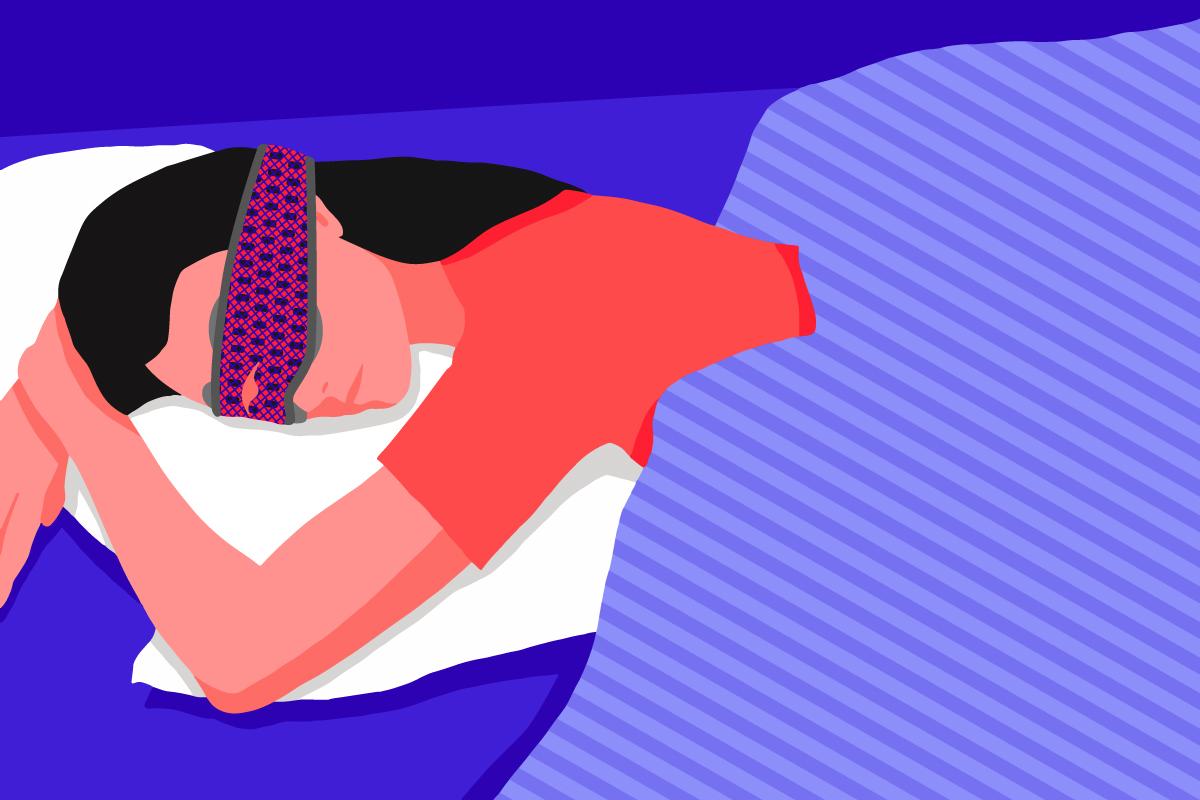 A girl sleeping on her stomach, wearing the best sleep mask for stomach sleepers.