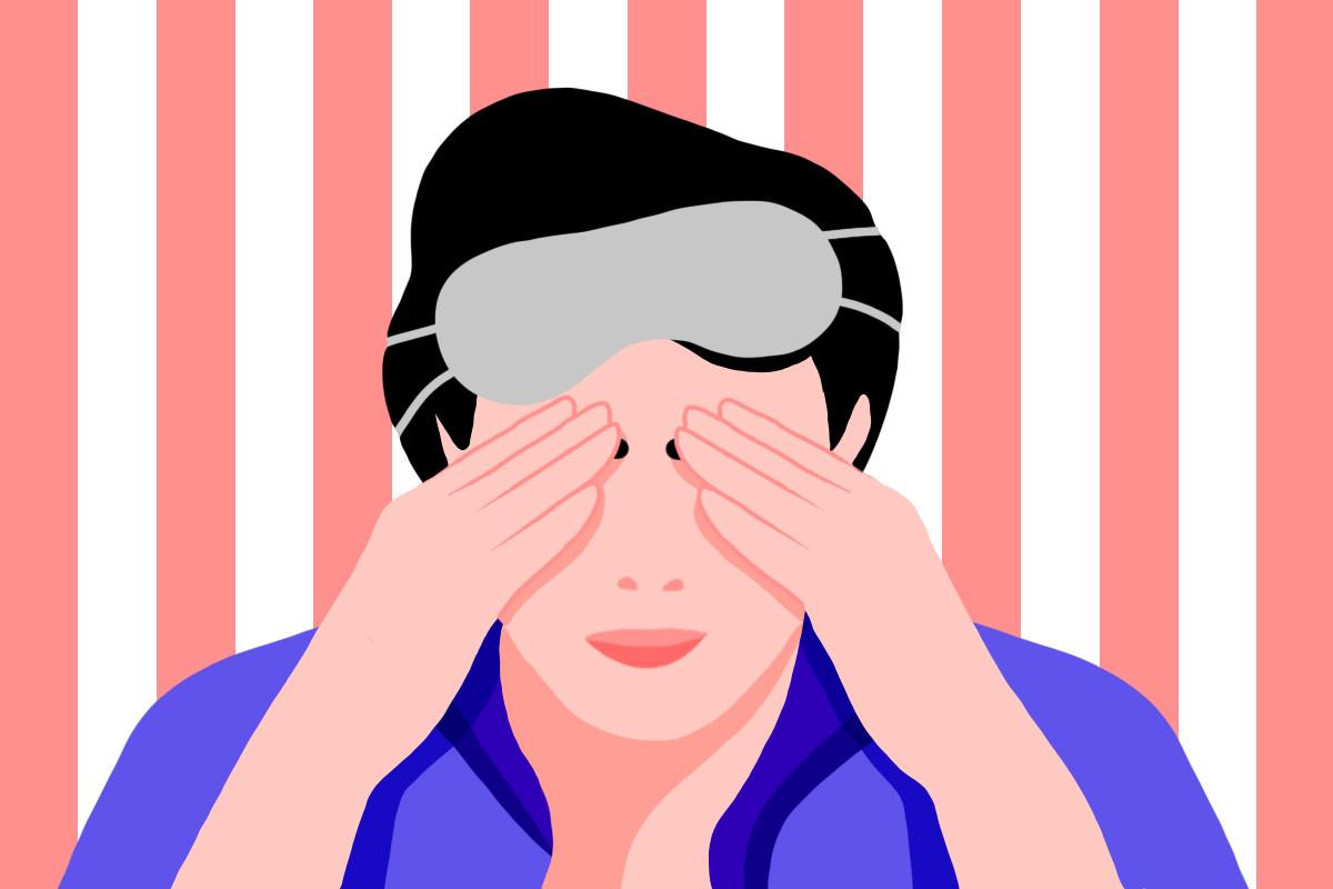 A man with a sleep mask on top of his head, holding his hands to his eyes to show how the hidden danger of sleep masks affects vision.