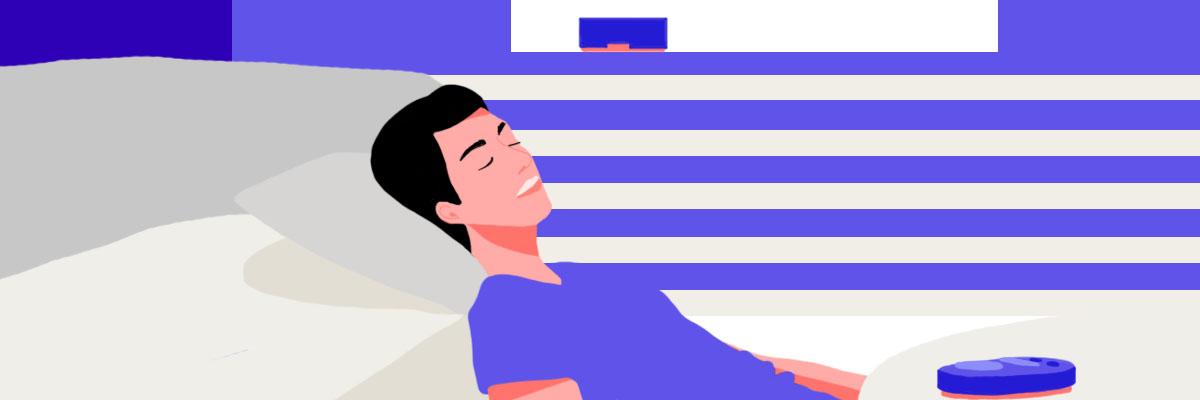 A man relaxing on the couch, listening to different kinds of colored noise on a white noise machine.