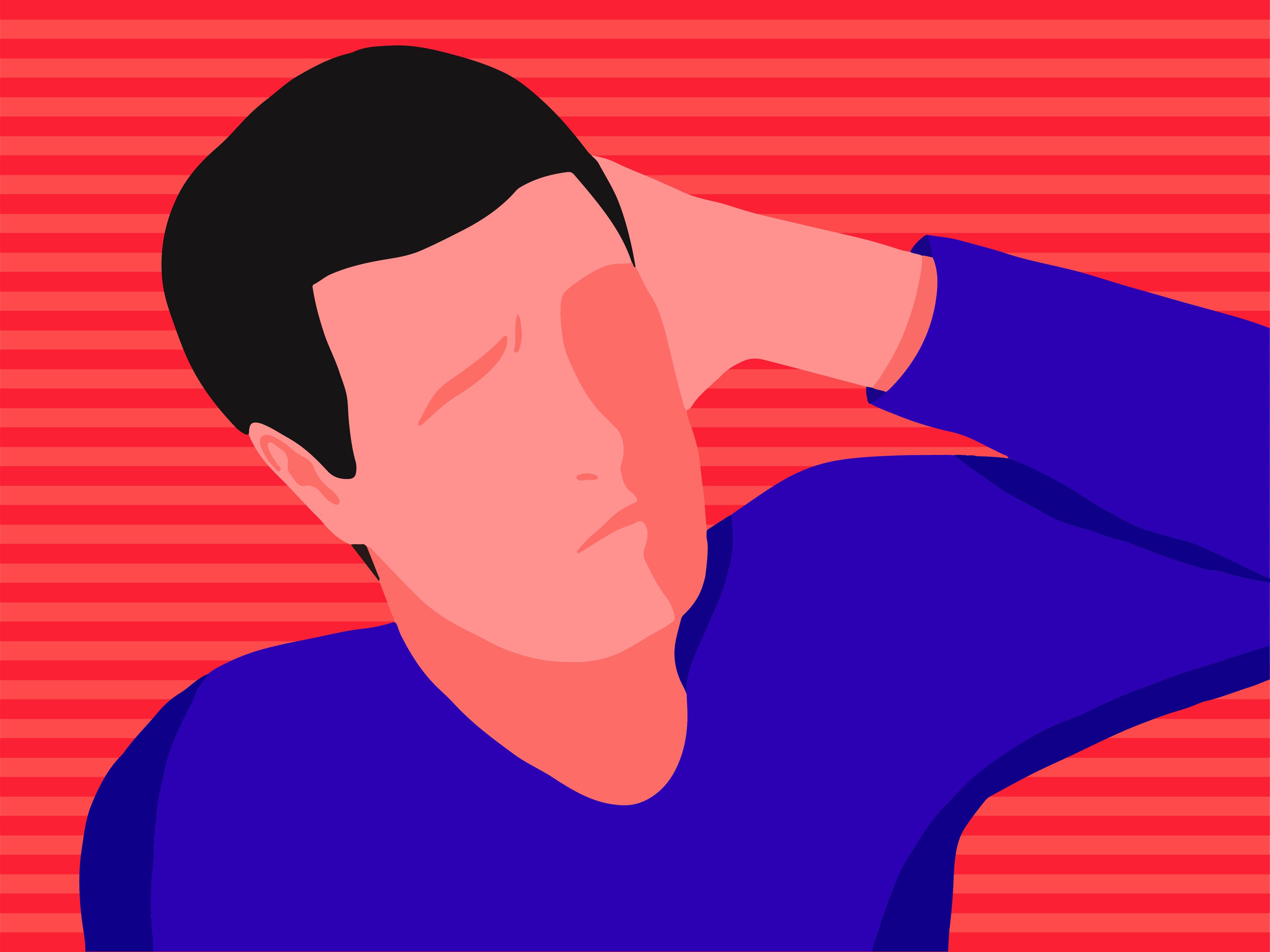 A man with an ear infection holding his hand to his ear.