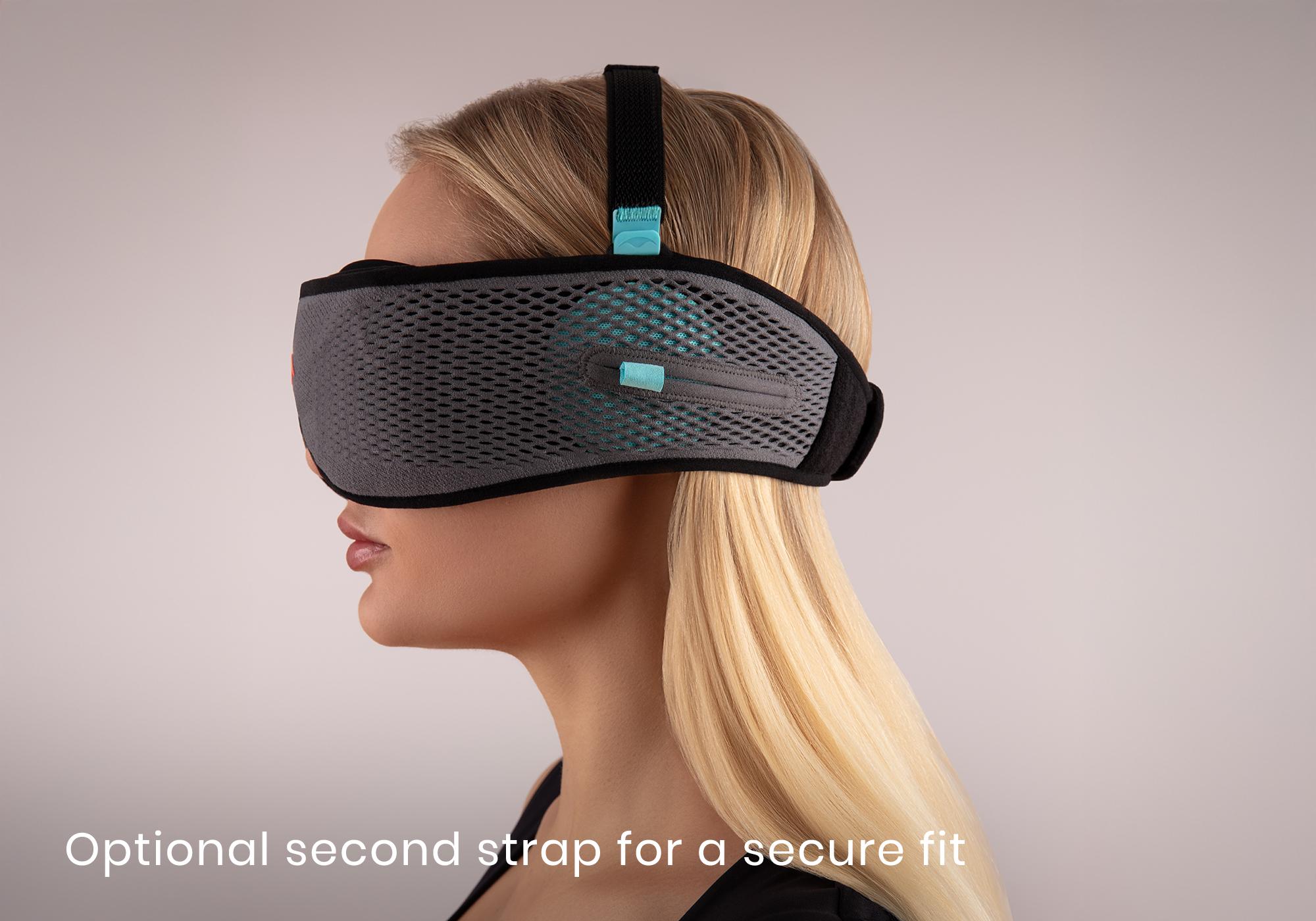 A blonde female wearing a Bluetooth sleep mask with an optional top strap securing it to her head.