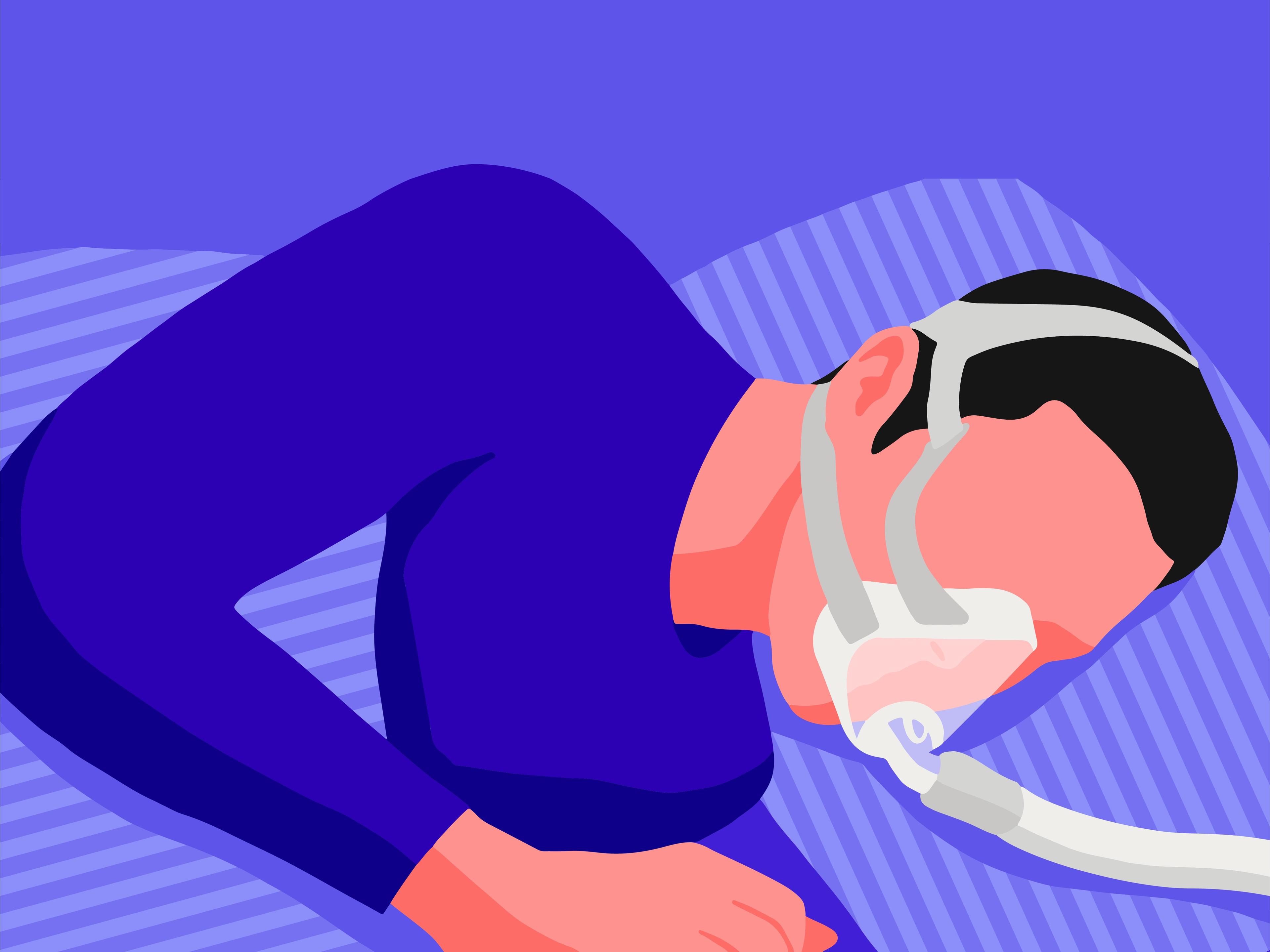 A male sleeping on his side while wearing a nasal pillow mask.