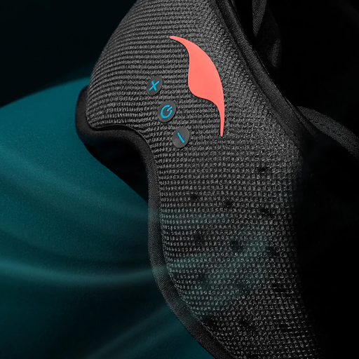 Air coming out of the perforations on the front of a black mesh sleep mask with headphones.