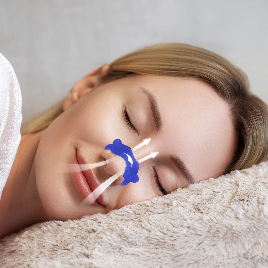 A woman sleeping with a blue nasal strip on her nose. Arrows indicate that air is passing through her nostrils.
